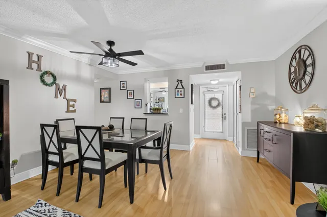 a view of a dining room with furniture and a chandelier