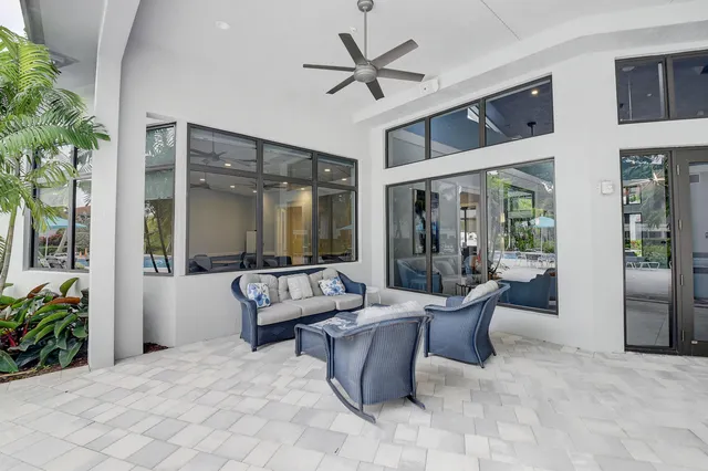 a living room with furniture a rug and a large window