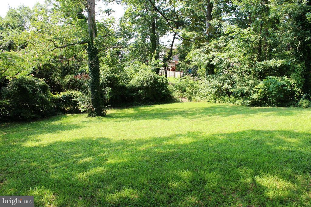 46695 Yorktown Road Lexington Park, MD 20653 - Photo 13 of 14 a view of a grassy field with trees in the background