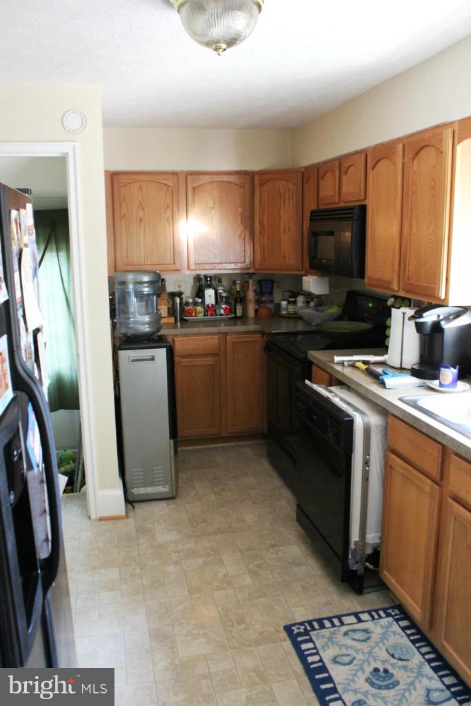 46695 Yorktown Road Lexington Park, MD 20653 - Photo 6 of 14 a kitchen with stainless steel appliances granite countertop a stove a sink dishwasher and a refrigerator