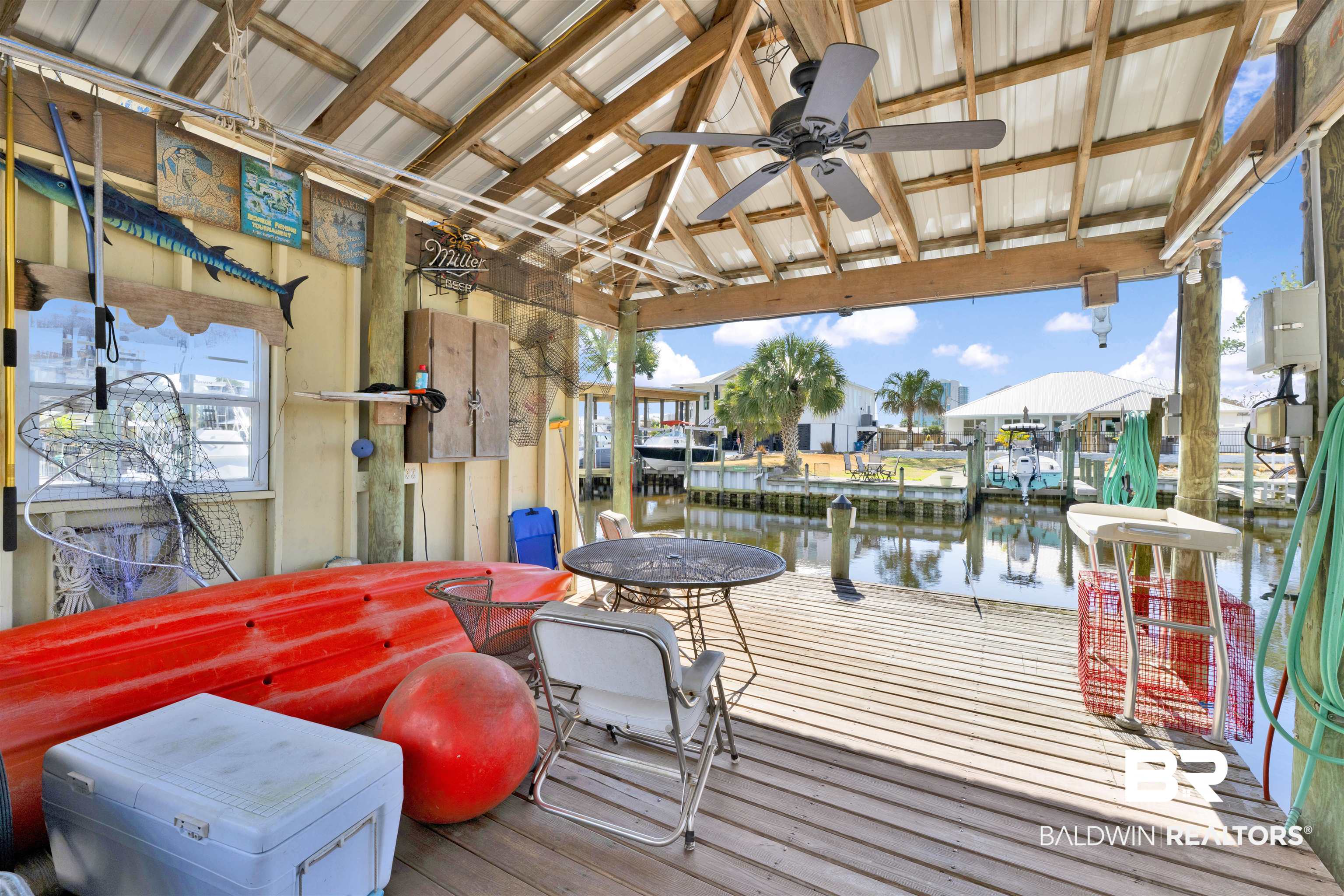 26222 Marina Road Orange Beach, AL 36561 - Photo 7 of 38 Wooden deck with a water view, a dock, ceiling fan, and boat lift