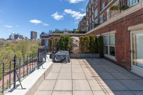 a view of a patio with a table and chairs