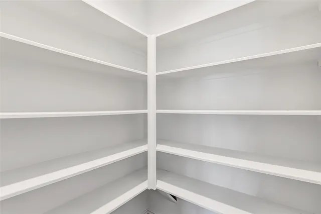 a kitchen with granite countertop a sink a stove and cabinets
