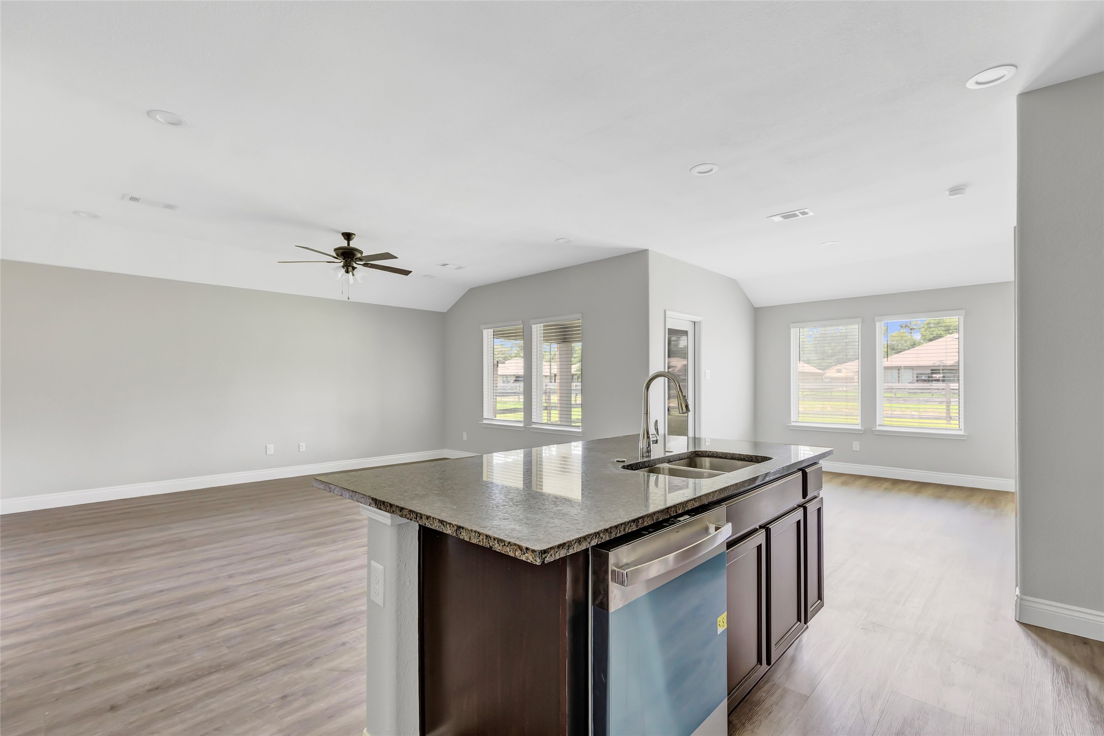 214 Kickapoo Drive Anahuac, TX 77514 - Photo 13 of 36 an empty room with wooden floor and chandelier