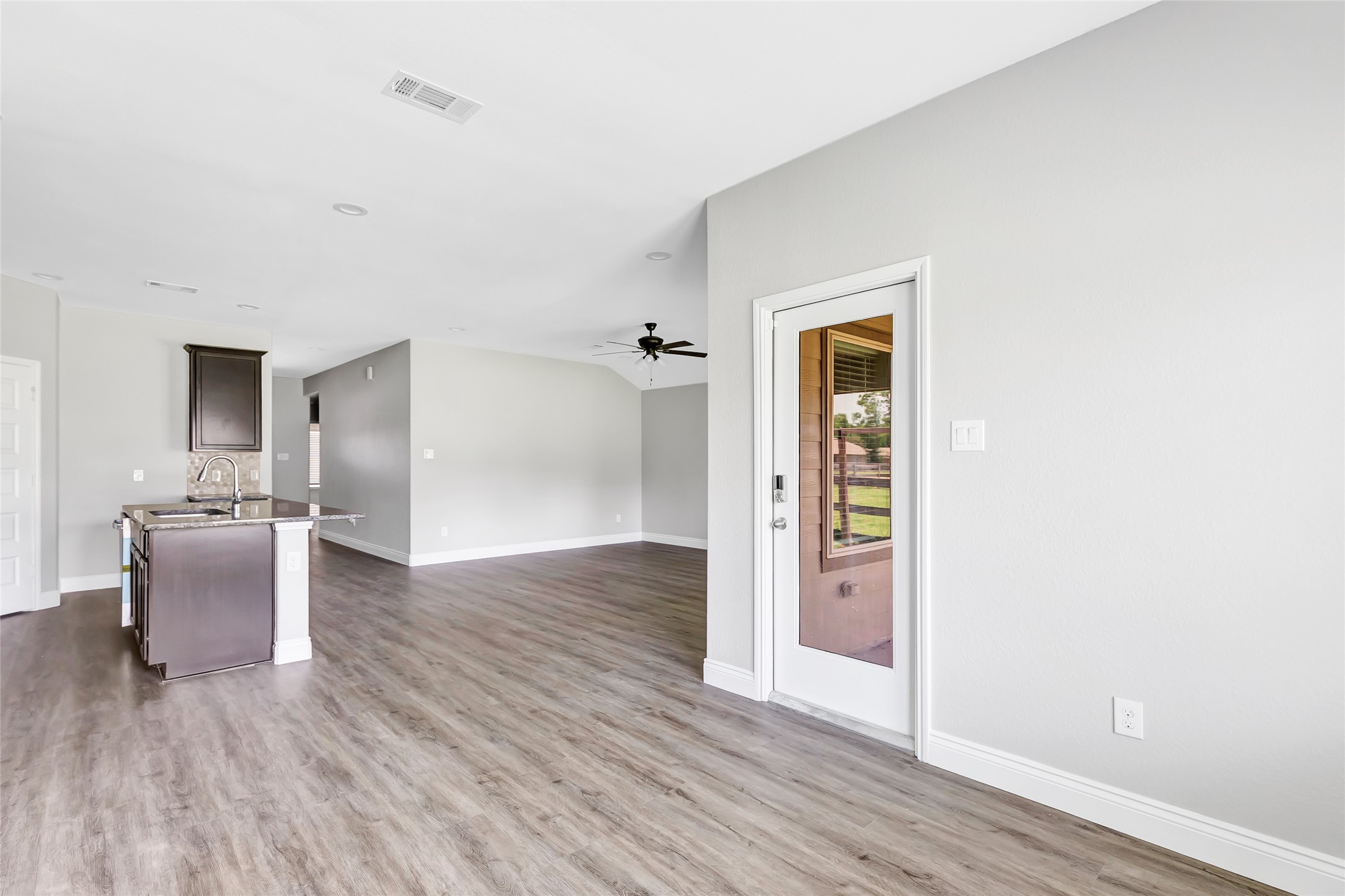 214 Kickapoo Drive Anahuac, TX 77514 - Photo 15 of 36 an empty room with wooden floor and a window