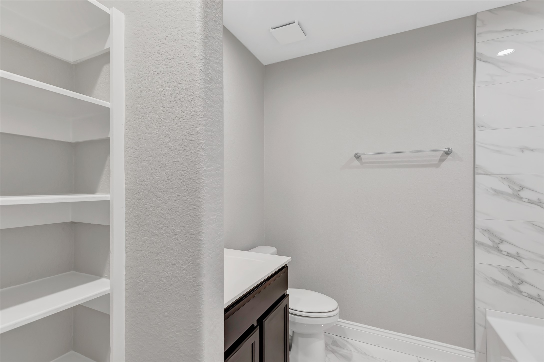 214 Kickapoo Drive Anahuac, TX 77514 - Photo 17 of 36 a bathroom with a granite countertop toilet and a sink