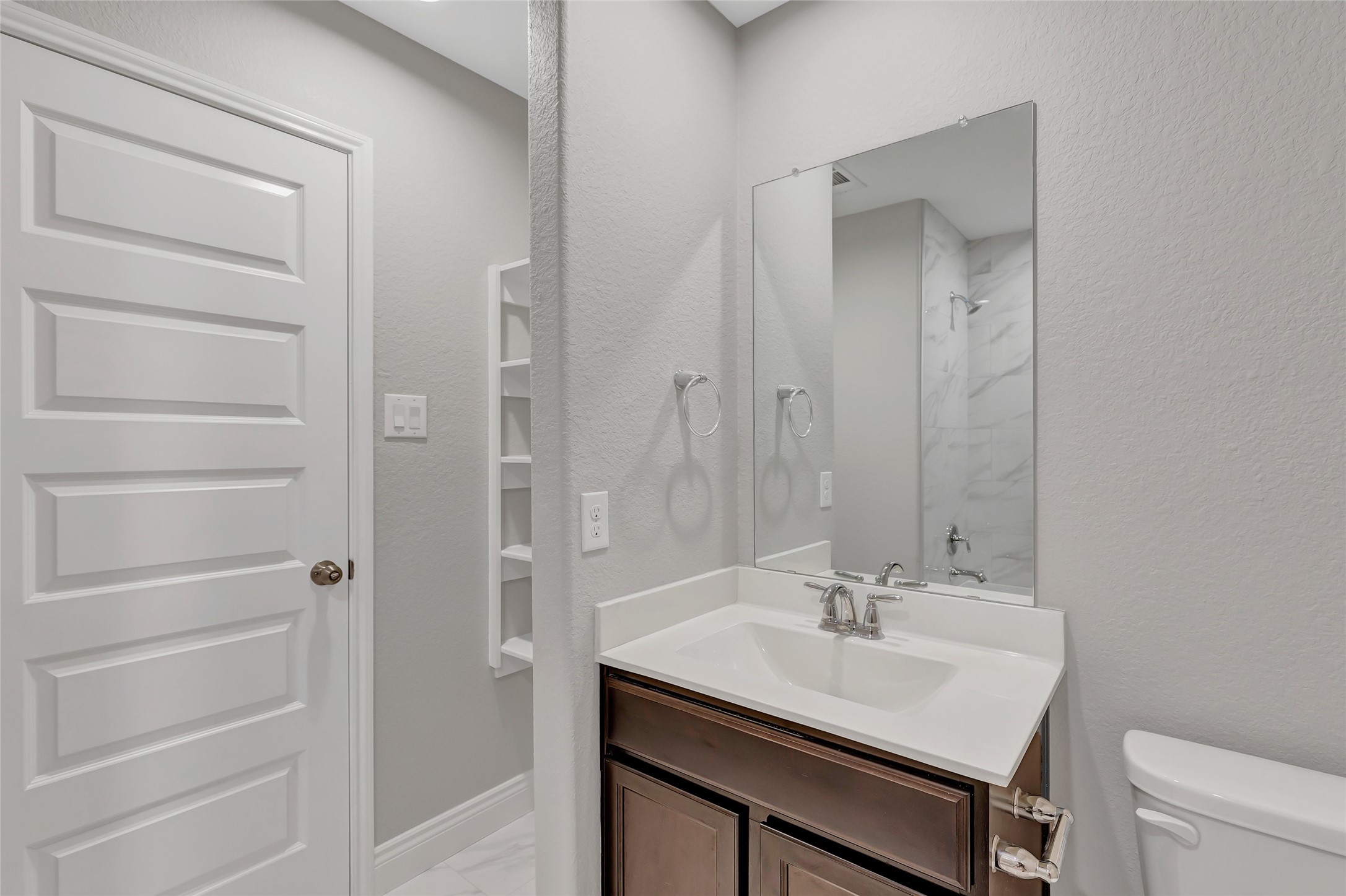 214 Kickapoo Drive Anahuac, TX 77514 - Photo 19 of 36 a bathroom with a sink a toilet and shower