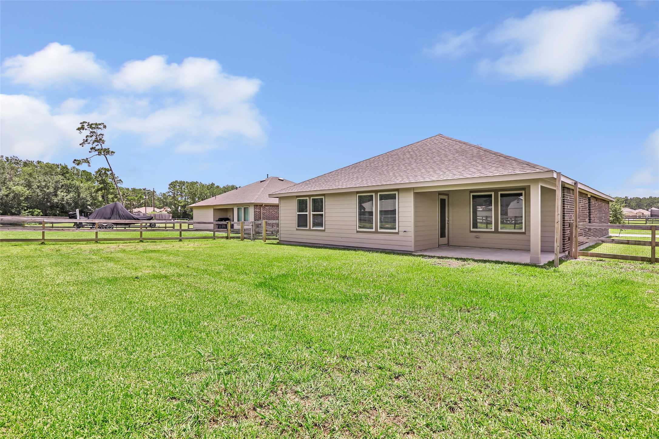 214 Kickapoo Drive Anahuac, TX 77514 - Photo 33 of 36 a view of a house with a backyard