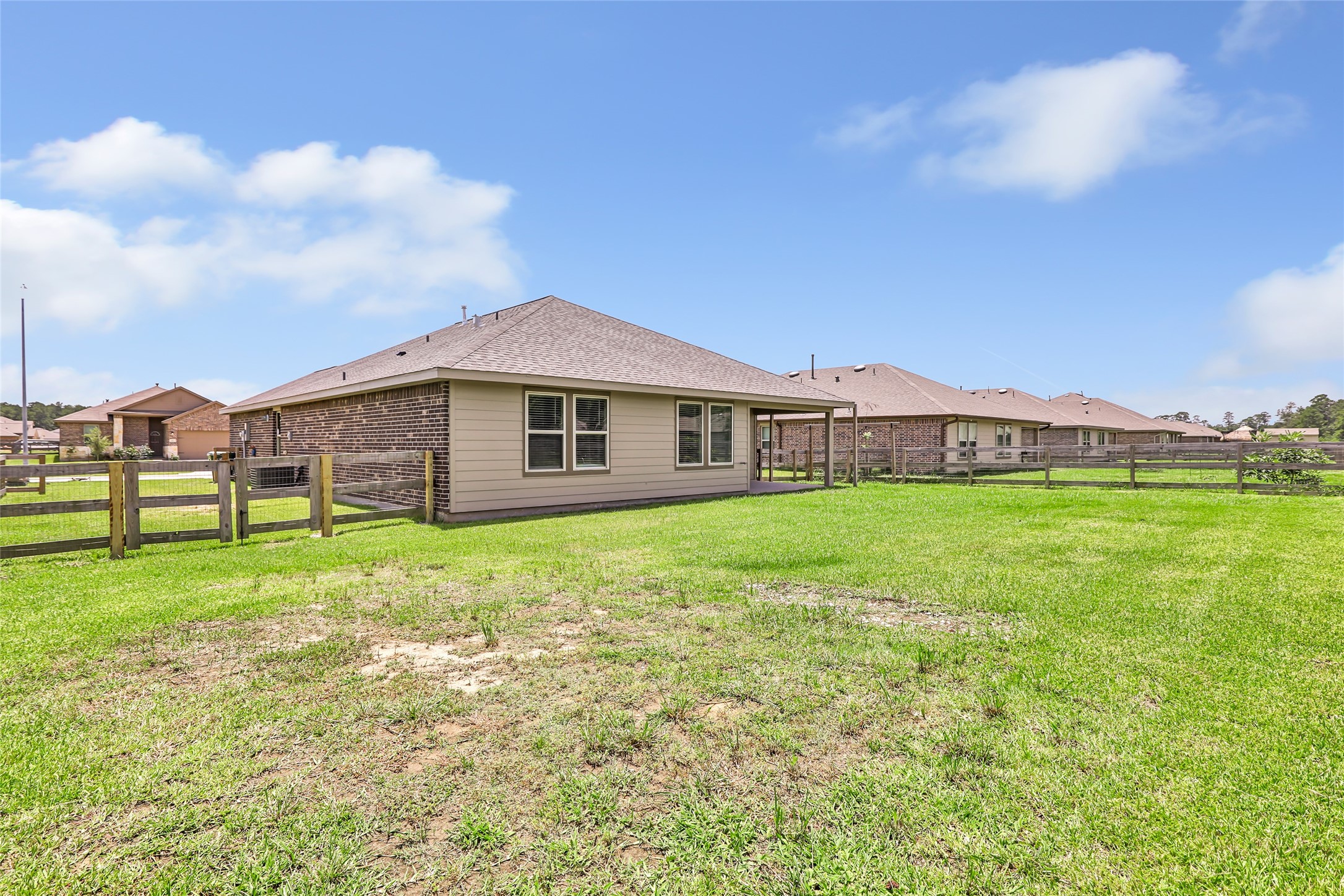 214 Kickapoo Drive Anahuac, TX 77514 - Photo 34 of 36 a view of an house with backyard space and balcony