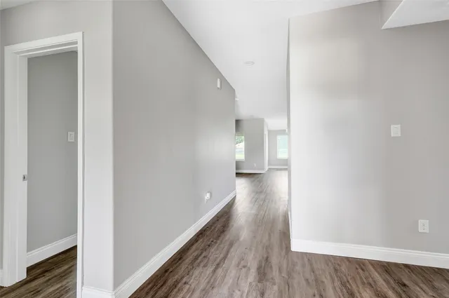 a view of a hallway with wooden floor