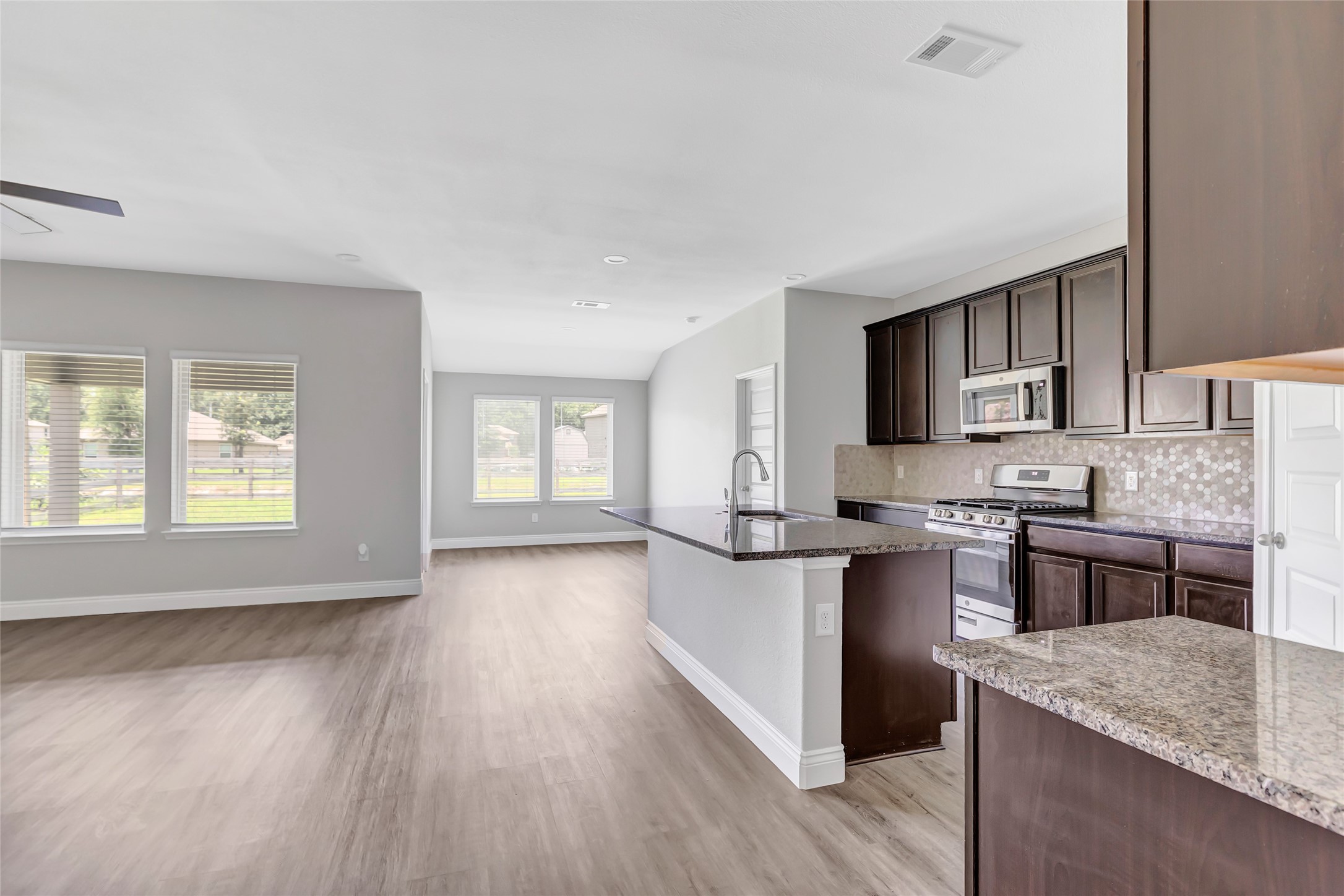 214 Kickapoo Drive Anahuac, TX 77514 - Photo 8 of 36 a kitchen with stainless steel appliances granite countertop a sink stove and refrigerator