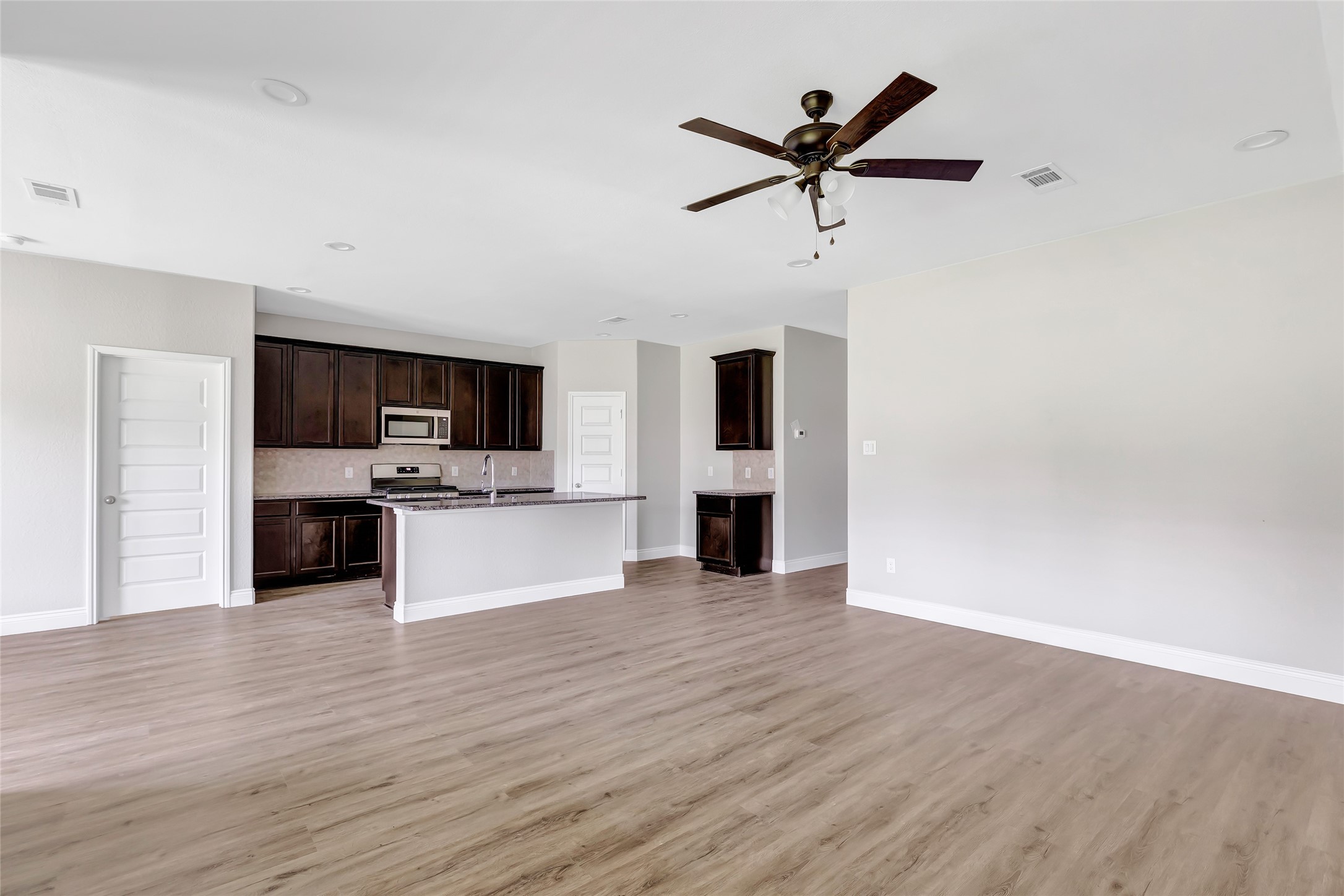 214 Kickapoo Drive Anahuac, TX 77514 - Photo 9 of 36 a view of kitchen with sink microwave and stove
