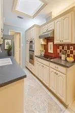 a kitchen with sink cabinets and appliances