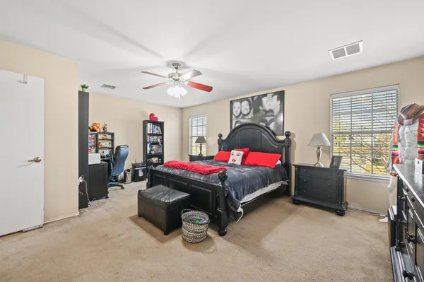 a bedroom with furniture and windows