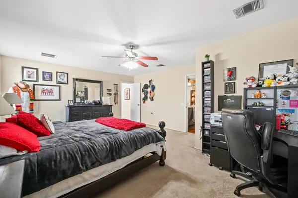 a bedroom with two beds and a desk