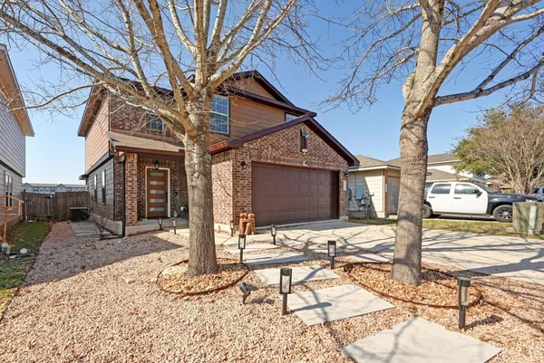 a front view of a house with a yard