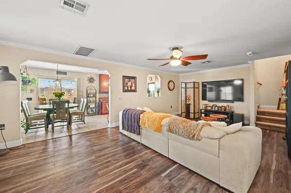 a living room with furniture and wooden floor