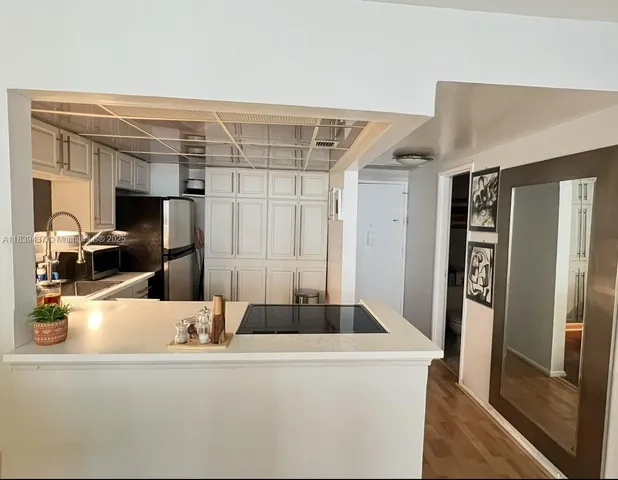 a kitchen with a refrigerator and a sink