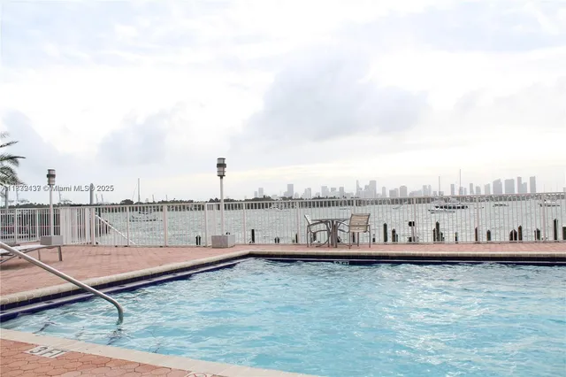 a room with lots of gym equipment and a chandelier