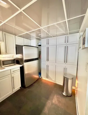 a kitchen with refrigerator and window