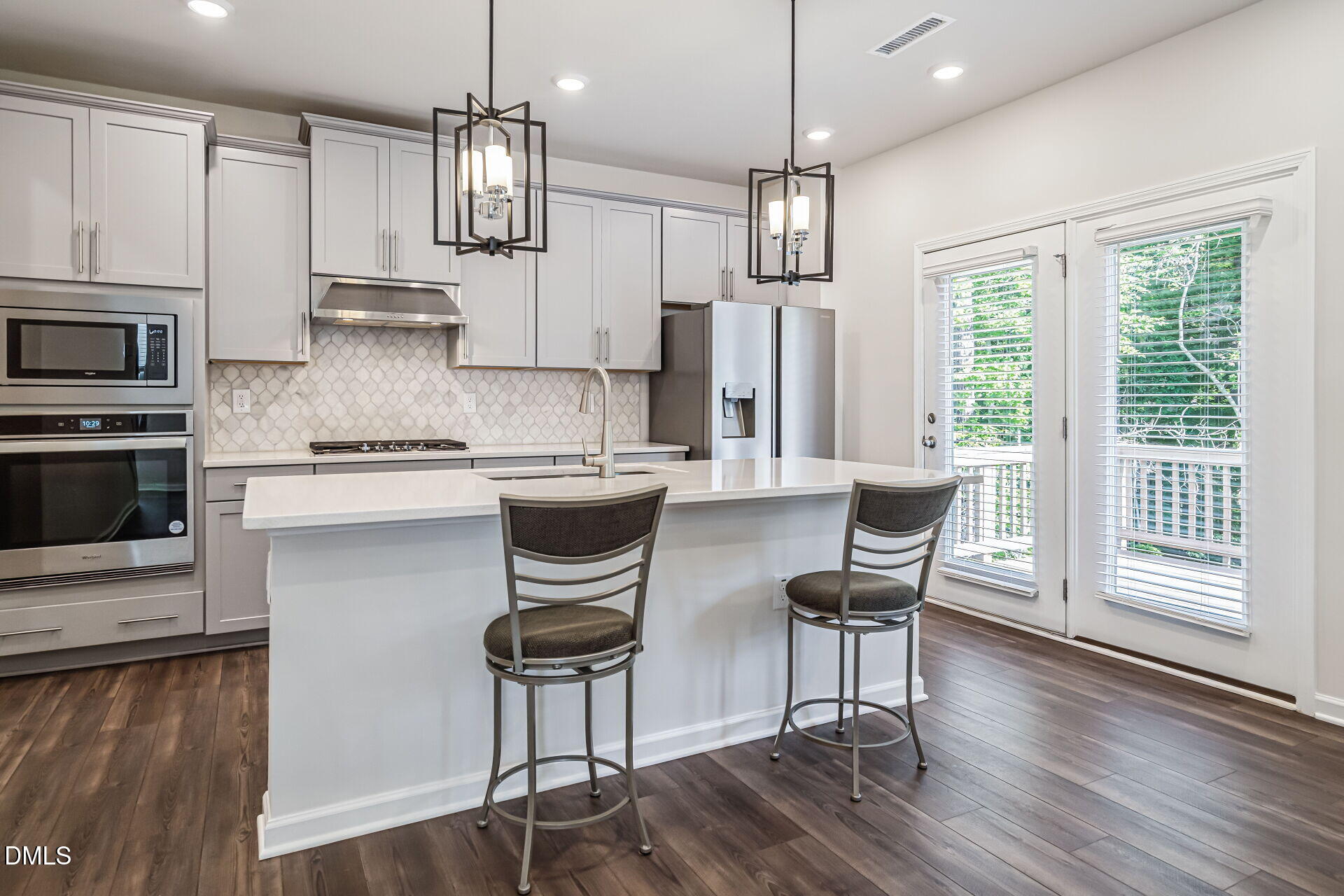 3205 Collaborative Way Raleigh, NC 27610 - Photo 10 of 34 a kitchen with stainless steel appliances granite countertop a kitchen island hardwood floor and a sink