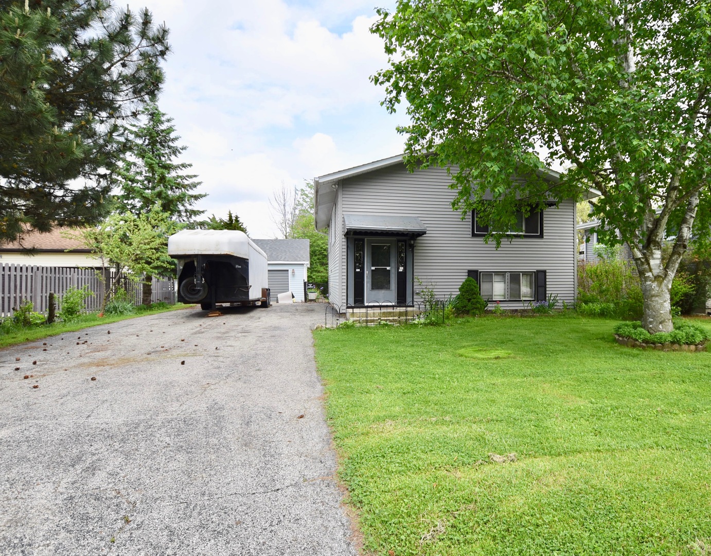 a view of house with outdoor space and garden