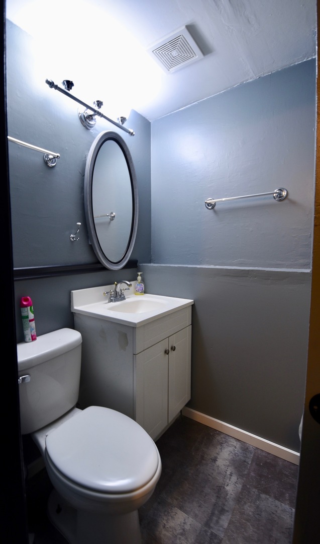 13 Tweed Road Fox Lake, IL 60020 - Photo 12 of 23 a bathroom with a toilet a sink and a mirror