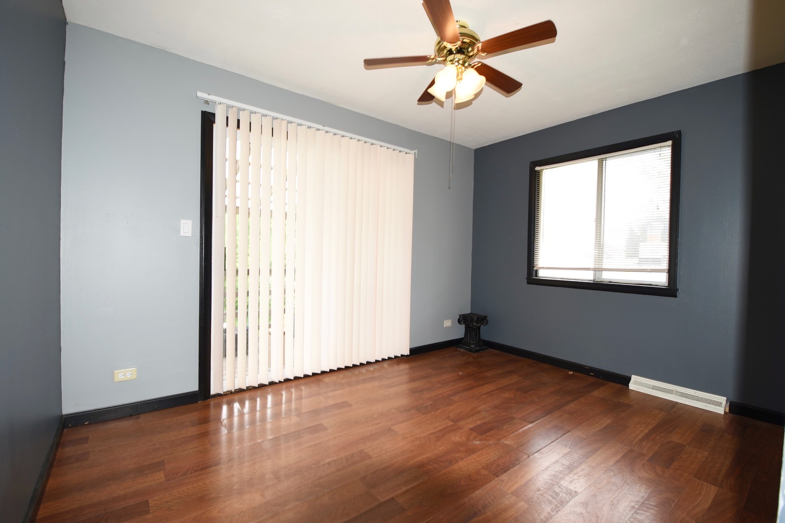 13 Tweed Road Fox Lake, IL 60020 - Photo 17 of 23 an empty room with wooden floor fan and windows