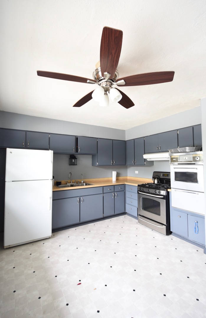 13 Tweed Road Fox Lake, IL 60020 - Photo 7 of 23 a kitchen with stainless steel appliances kitchen island sink refrigerator and stove