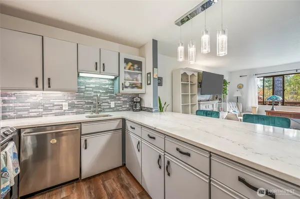 a kitchen with cabinets appliances and a counter space
