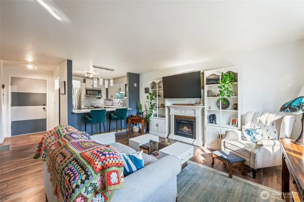 a living room with furniture a flat screen tv and a fireplace