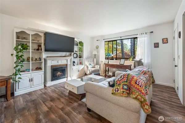a living room with furniture a fireplace and a flat screen tv