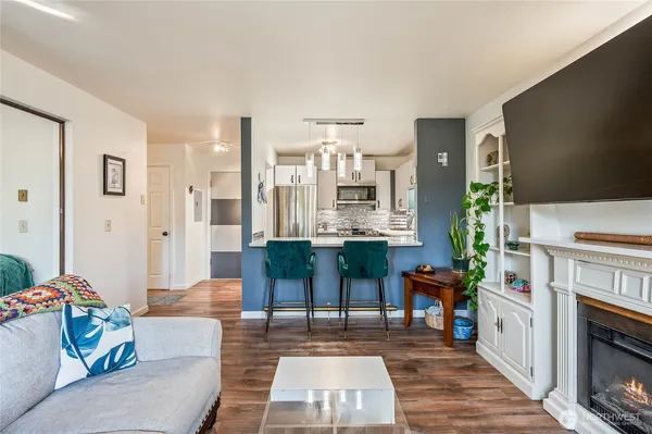 a living room with furniture and wooden floor