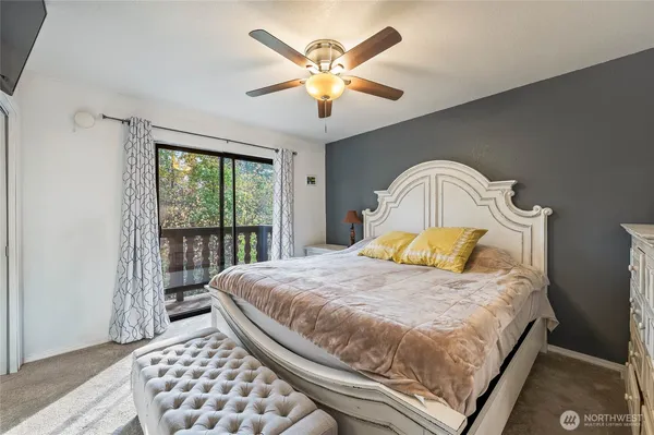 a bedroom with a large bed and a large window