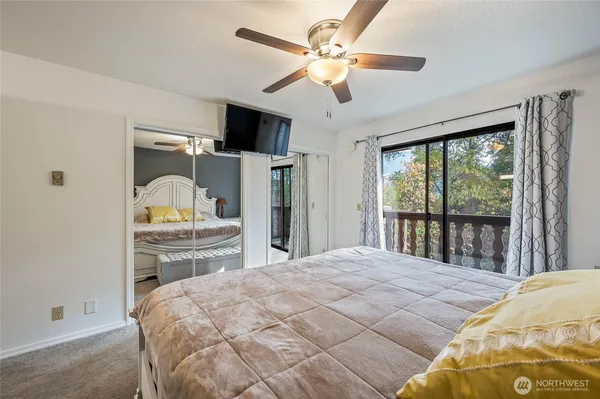 a bedroom with a large bed and a chandelier