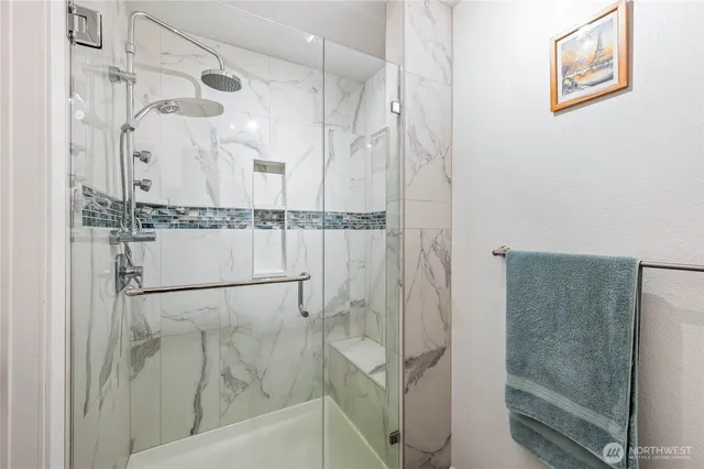 a bathroom with a glass shower door