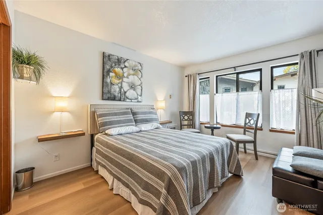 a bedroom with a large bed and a window