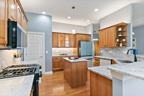 a kitchen with stainless steel appliances granite countertop a stove and a sink