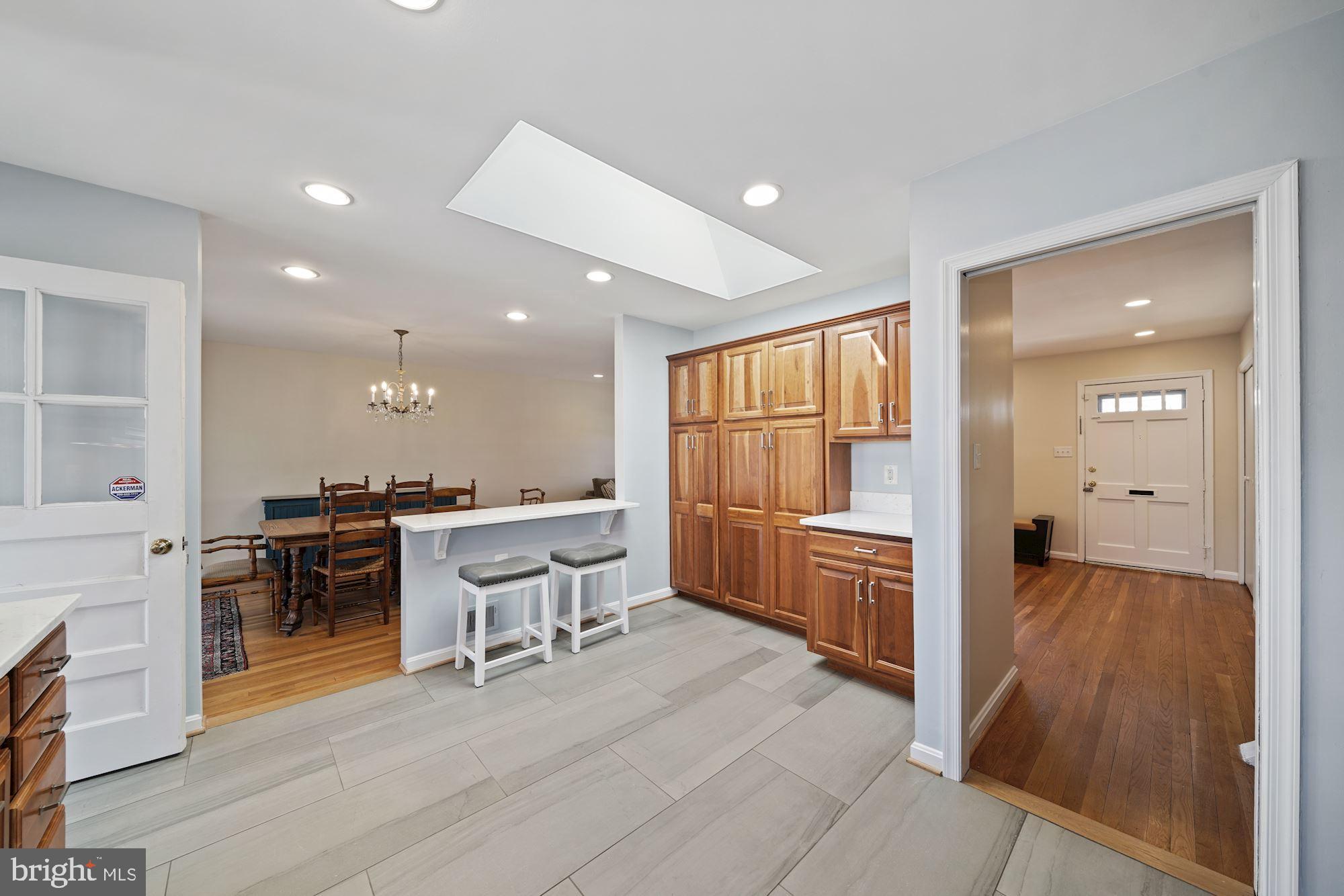 9709 Byeforde Road Kensington, MD 20895 - Photo 7 of 35 Kitchen Opening to Dining Area with Island