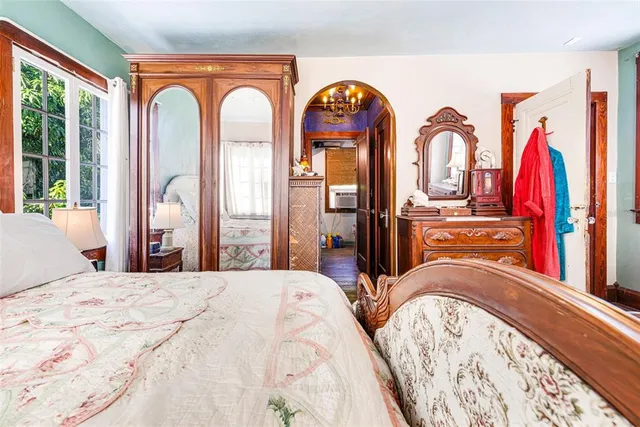 a bedroom with a bed and a large mirror