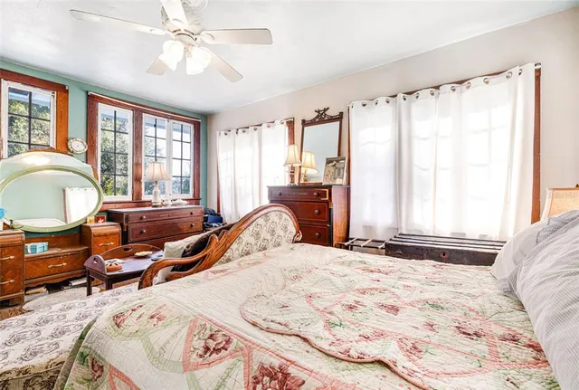 a bedroom with a bed a table and chair