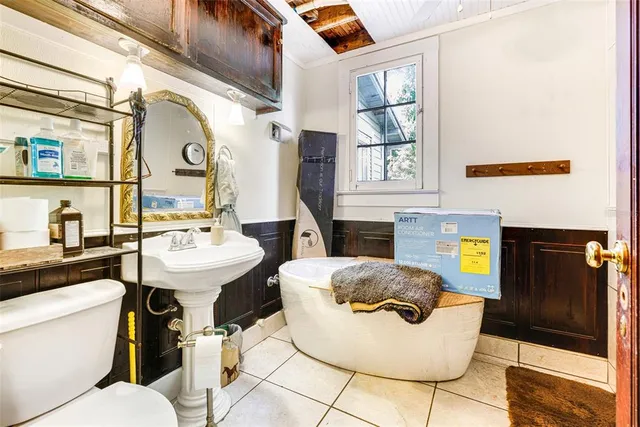 a bathroom with a sink toilet and mirror
