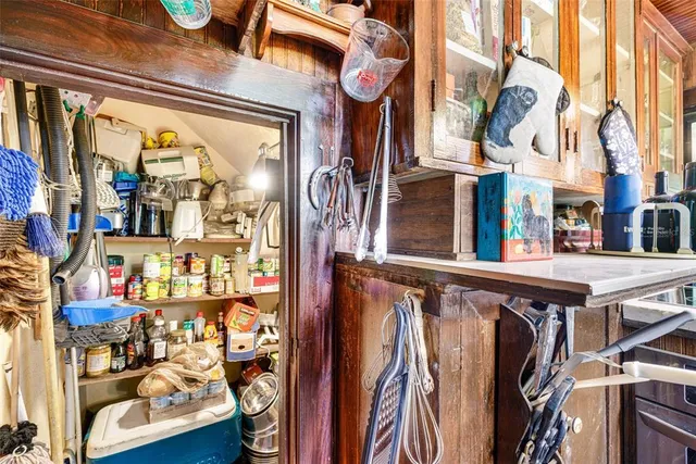 a view of kitchen with furniture and electronic appliances