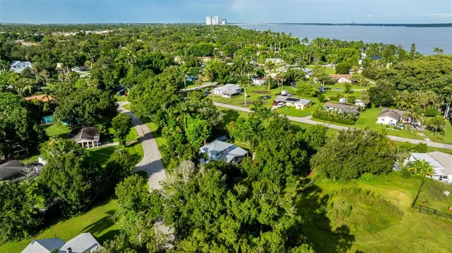 a backyard of a house with lots of green space and lake view