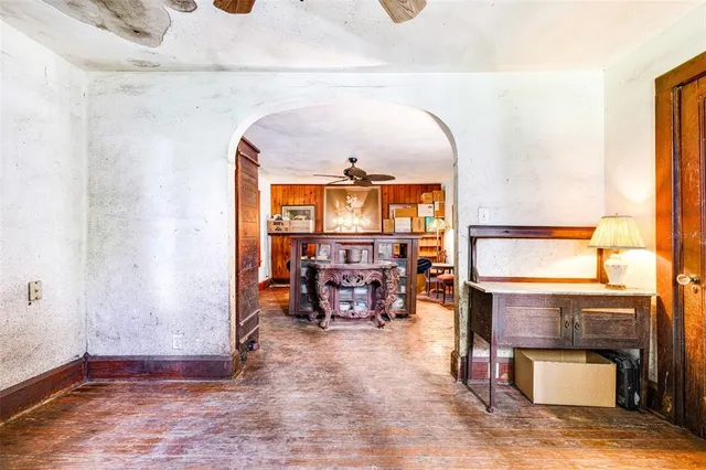 wooden floor with a fireplace and a table