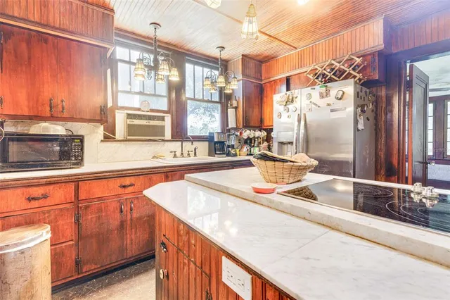 a kitchen with stainless steel appliances granite countertop a sink and a counter space
