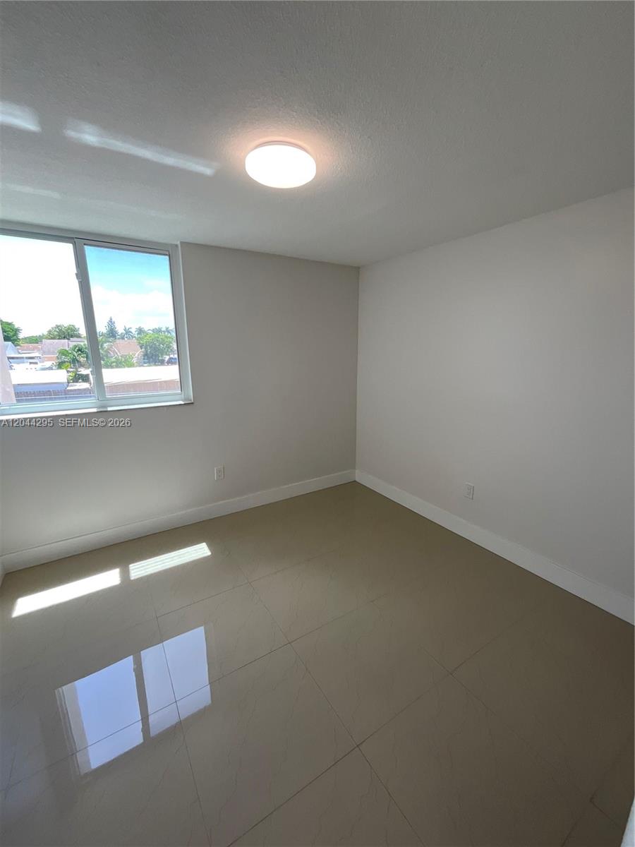 9441 Southwest 4th Street, Unit 214 Miami, FL 33174 - Photo 14 of 22 an empty room with a window