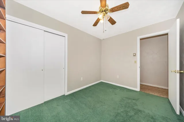 an empty room with a fan and a fan