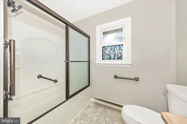 a white toilet sitting next to a bathroom sink