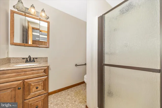 a bathroom with a sink vanity and a mirror